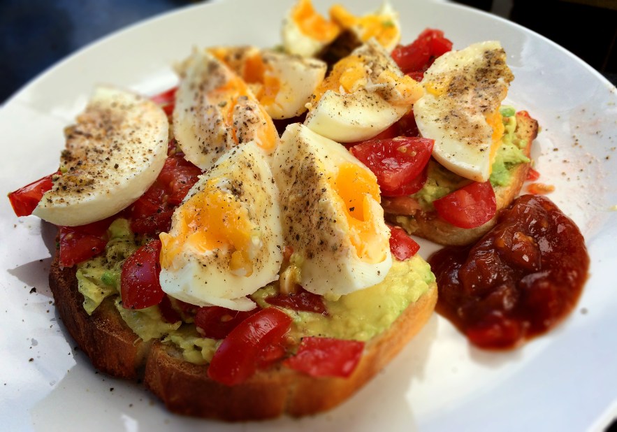 avo and tomato on toast with boiled eggs